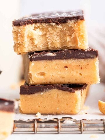 Stack of no bake peanut butter bars with chocolate topping.