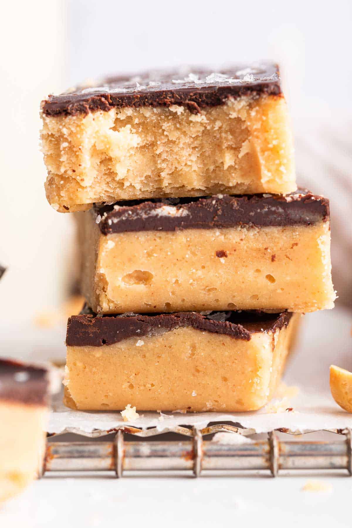 Stack of no bake peanut butter bars with chocolate topping.