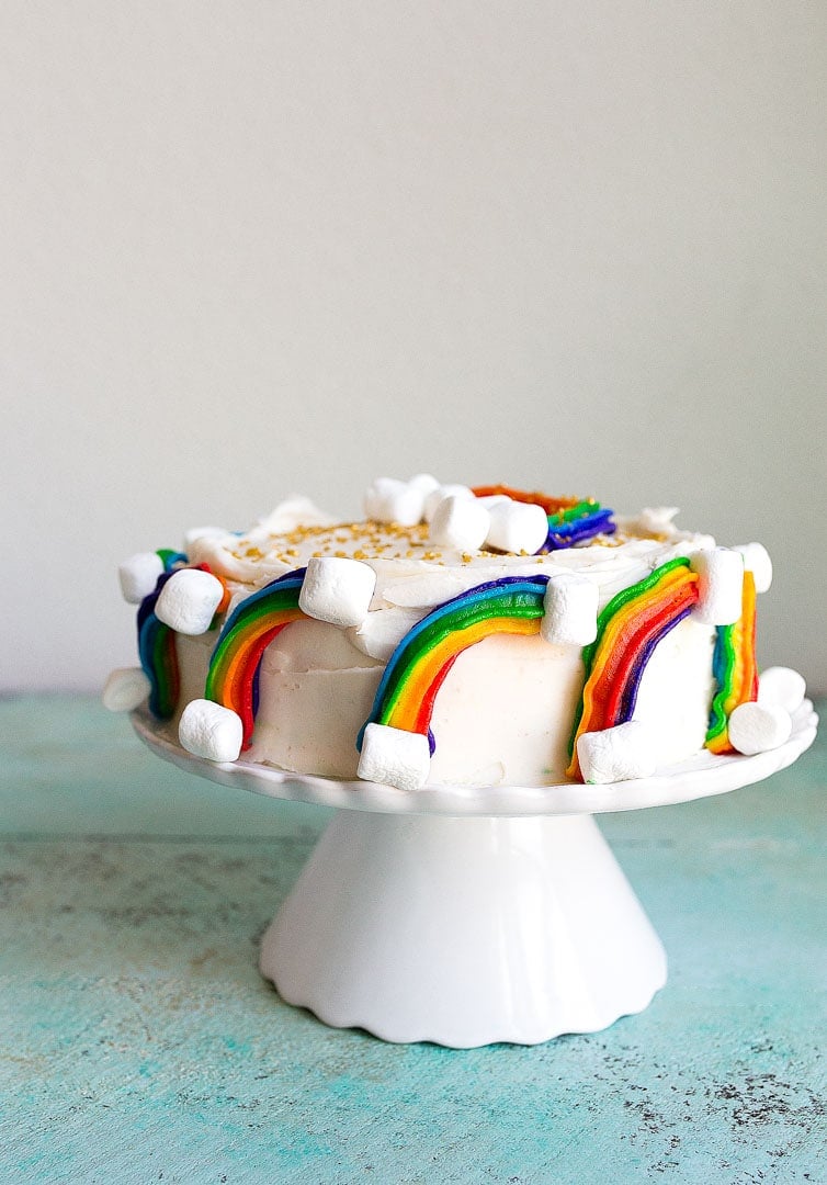 Rainbow Cake Recipe With Marshmallow Clouds And Gold Sprinkles