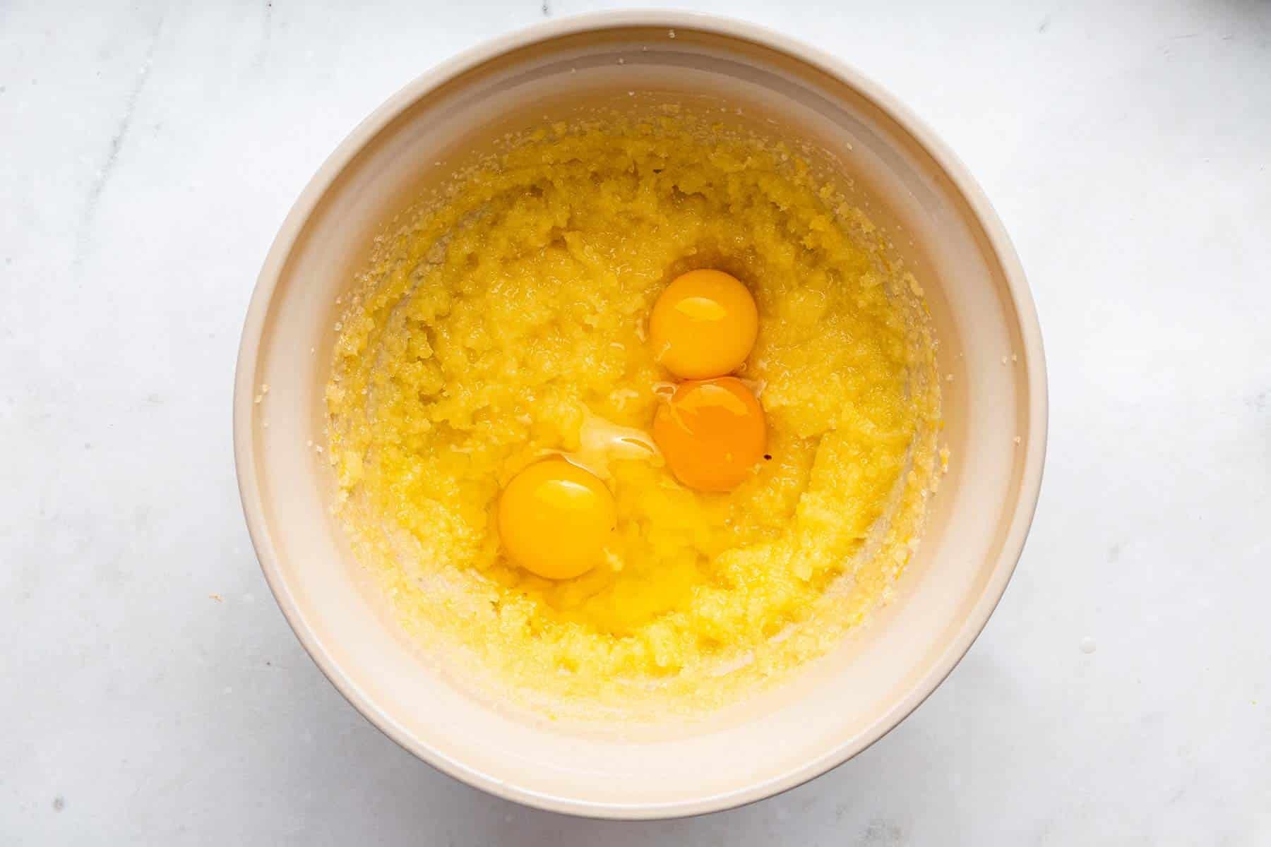 Yellow batter with three egg yolks on top of it.